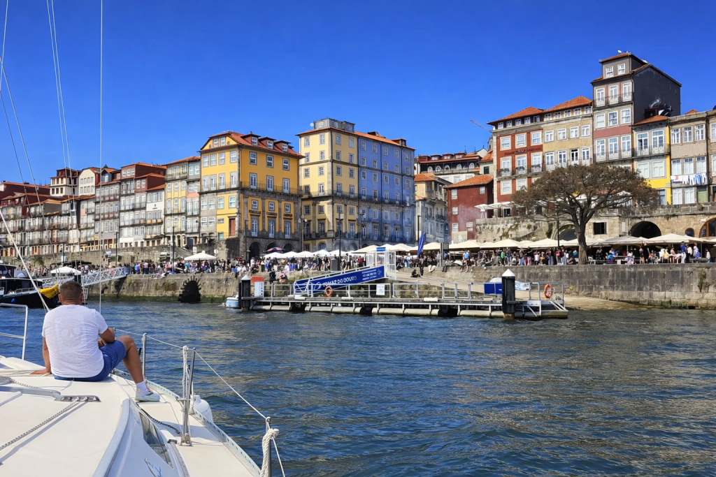 Sailing past the Ribeira district in Porto with colorful riverside buildings along the Douro River